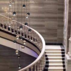 a spiral staircase with glass balls hanging from it