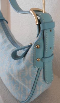 "Beautiful and cute clutch/shoulder handbag Light sky blue, leather trim, adjustable strap Logo on canvas and the key Zipper closure Three pockets: two open pockets: one small and the other larger and one zipper pocket Interior stain - see photo. Otherwise, it's in great condition. No stain on canvas Dimensions Width 10 2/4\" Height 5 1/2\" Depth 4\" Strap length 25 1/2\" Strap drop 9 1/2\"" Blue Shoulder Bag With Metal Hardware And Double Handle, Everyday Blue Shoulder Bag With Metal Hardware, Blue Shoulder Bag With Metal Hardware For Travel, Blue Shoulder Bag With Metal Hardware For Everyday Use, Blue Tote Shoulder Bag With Metal Hardware, Yellow Leather Bag, Burlap Tote Bags, Vegan Tote Bag, Boho Crossbody Bag