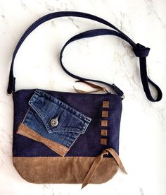 a blue and brown purse sitting on top of a white counter