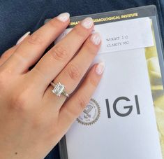 a close up of a person's hand with a ring on top of it