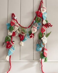 an ornament hanging on the side of a white wall with red and green decorations