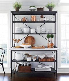 a shelf with dishes and cups on it