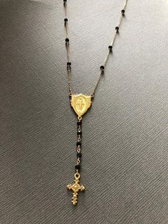 "This is a gorgeous rosary necklace with Onyx gemstone on Goldfilled chain and clasp. Necklace is 16\" with 2\" extender with 18k gold filled Miraculous Mary medallion hangs at center with 2\" drop. This special Necklace will arrive to you or someone special in a gift box." Elegant Adjustable Crucifix Jewelry, Adjustable Crucifix Necklace With Adjustable Chain, Elegant Adjustable Rosary With Crucifix, Rosary Necklace Without Cross, Rosary Inspired Necklaces, Adjustable Elegant Crucifix Rosary, Elegant Rosary With Adjustable Chain, Adjustable Gold Rosary With Cross, Elegant Adjustable Crucifix Rosary