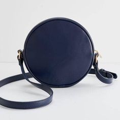 Carry your everyday essentials in this gorgeous Chloe Dormouse Embroidered Circle Bag. We adore the navy blue ground almost as much as the intricately embroidered resting fawn. Perfect for adding luxe woodland vibes to your wardrobe. One interior zip pocket. Chloe dormouse embroidered circle bag - navy Dormouse design created by Chloe Giordano Vegan leather 100% polyester lining / 100% polyurethane outer Wipe clean with damp cloth Measures 7.9"L x 7.9"W x 2.4"H Imported Chloe Giordano, Navy Blue Handbag, Navy Blue Handbags, Blue Handbag, Circle Bag, Conscious Consumer, The Navy, Personalized Accessories, Everyday Essentials