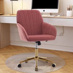 a pink office chair sitting in front of a computer monitor on top of a desk