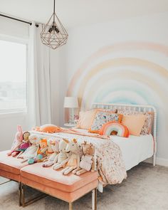 a bed with stuffed animals on top of it in a bedroom next to a window