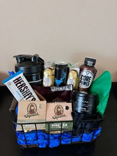 a basket filled with drinks and snacks on top of a table