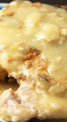 a close up of food on a plate with gravy and meat patties