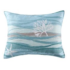 a blue pillow with a white tree and starfish on the front, sitting on a white background