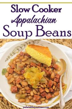 a white plate topped with beans and corn on top of a wicker table cloth