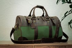 Canvas duffle bag "Safari" is made of high-quality Canvas textiles and CrazyHorse genuine leather. The Travel bag for men combines lightness and practicality, the accessory will become indispensable for business trips, the gym and travel. 📐Dimensions weekend bag: Length 20 inch (50 cm) Depth - 10 inch (25 cm) Height - 11 inch (28 cm) ✔️Features fo Canvas bag: - the parameters meet international standards for hand luggage; - a combination of materials - genuine leather + canvas; - Duffle bag hav Luxury Bags With Leather Trim For Outdoor, Luxury Outdoor Bags With Leather Trim, Green Leather Duffle Bag With Luggage Sleeve, Green Leather Shoulder Bag With Leather Trim, Leather Duffle Bag With Large Capacity For Outdoor, Leather Weekender Bag For Outdoor Use, Leather Weekender Bag With Leather Trim For Outdoor, Green Leather Travel Bag With Luggage Sleeve, Outdoor Leather Weekender Bag With Leather Trim