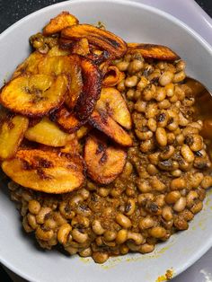 a white bowl filled with beans and bananas