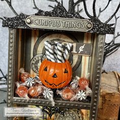 a halloween card with an orange jack - o'- lantern and candy in it