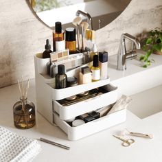 a bathroom counter with various items on it and a mirror in the backround