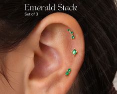 an ear with three small green stones on it