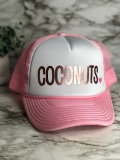 "Coconuts hat, pictured here in the kids small size in gray/white with the design in gold foil. Neon pink heart will be added unless requested otherwise- if you want a different colored heart or no heart just leave a note in the comments at checkout. These unique custom MADE TO ORDER hats are truely one of a kind. Not all heads are created equal , which is why we have so many size options. You can customize your hat color, size and your favorite design. please note all hat colors vary by size, i Personalized Pink Snapback Hat, Customizable Pink Hat With Curved Brim, Pink Personalized Baseball Cap, Personalized Pink Cap, Customizable Pink Snapback Hat, Customizable Pink Baseball Cap For Gift, Customizable Cute Adjustable Baseball Cap, Customizable Adjustable Cute Baseball Cap, Customizable Pink Snapback Hat With Curved Brim