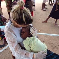 a woman holding a child in her arms