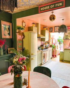 a kitchen filled with lots of green furniture and decor on top of a wooden table