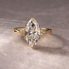 an engagement ring with a pear shaped diamond in the center