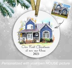 a christmas ornament with a house and two photos hanging from it's side