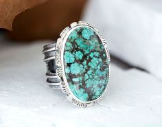 One-of-a-Kind Turquoise Statement Ring from Treasure Mountain - Southwestern Style Jewelry. This chunky ring has been handmade using scrap 925 Sterling Silver that has been fused, patinaed and polished. The setting is an 30mm x 21mm oval Treasure Mountain Turquoise Cabochon that is in a Bezel setting accented with stamped cutout square wire. The thick wide band is 3/4" then narrows to 1/2" for a comfortable fit. This ring cannot be resized. Size 10 Add a pop of turquoise to your jewelry collecti Handmade Rustic Silver Turquoise Ring, Adjustable Turquoise Ring With Patina For Gift, Unique Handmade Wide Band Round Ring, Handmade Bohemian Wide Band Ring For Anniversary, Handmade Rustic Oval Jewelry, Rustic Silver Turquoise Ring For Gift, Rustic Silver Turquoise Ring Gift, Rings Gifts, Turquoise Statement Ring