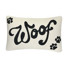 a dog pillow with the word woof written in black on it and paw prints