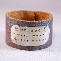 a leather bracelet with a message on it