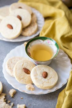 two plates with cookies and a cup of tea