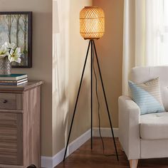 a living room with a white chair and a floor lamp