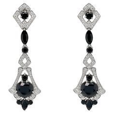 These exquisite earrings are crafted with meticulous attention to detail, inspired by the glamour and precision characteristic of the Art Deco era. At the heart of these earrings lie the captivating black spinels, each boasting a generous 4.70 carats. Surrounding the central spinels are an array of additional spinel gemstones, totaling an impressive 7.28 carats. Enhancing the elegance of these earrings are the shimmering F/G colored natural diamonds, totaling .79 carats. Set delicately in 18k white gold, these diamonds accentuate the overall brilliance of the design, creating a remarkable contrast against the darker gemstones. The intricate detailing and meticulous craftsmanship of these art deco-inspired earrings set them apart as a timeless piece of jewelry. These earrings also have a ma Spinel Gemstone, Black Spinel, Matching Rings, Art Deco Era, Art Deco Inspired, Inspiration Art, Timeless Pieces, Earring Set, Natural Diamonds