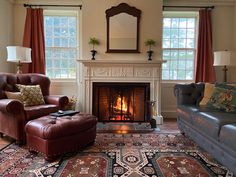 a living room filled with furniture and a fire place in the middle of a room