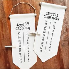 two days till christmas tags hanging on a wooden table with clothes pins attached to them