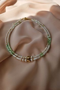 Dive into style with our Green Pearl Choker – a beach-inspired necklace for her. This everyday colorful choker, adorned with lustrous pearls, makes a perfect gift for Mom or any jewelry lover. Let the ocean's charm adorn your neckline! #PearlChoker #GreenPearlNecklace #BeachJewelry #GiftsForMom #EverydayElegance #JewelryLoverGifts Choker Pearl Necklace, Colorful Choker, Choker Pearl, Beach Necklace, Beach Necklaces, Necklace For Her, Mother Of Pearl Necklace, Green Pearls, Handcrafted Accessories