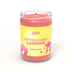 a pink candle that is sitting in front of a white background with the words cotton candy landing on it