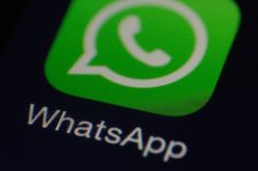 the whatsapp logo is displayed on an iphone