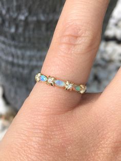 "Unique Opal and Diamond Band Ring. Vintage Sophisticated Opal band with Diamonds. Material: Solid Gold (14K & 18K) Finishing: High Polished, Shiny Fit: Standard Width: 2.2 mm, Top 3.4mm w/ Xs, 2.7mm w/o Xs Height: 1.4 mm, top - 1.9mm Setting: Bezel Stone: Natural Opals Shape: Marquise Size: 2mm x 4mm Quantity: 3 Opals Stone: Authentic Diamonds Conflict Free Clarity: VS Color: G-H Cut: Brilliant Quantity: 4 x 1.3mm Diamonds This matching band will turn your Engagement Solitaire into a Weddin Gold Opal Wedding Ring Stamped 14k, Gold Gemstone Eternity Band For Promise, Gold Eternity Band With Gemstone For Promise, Yellow Gold Multi-stone Opal Ring For Wedding, Adjustable Gold Opal Ring For Wedding, Adjustable Multi-stone Wedding Rings, Stackable Yellow Gold Opal Wedding Ring, Gold Multi-stone Diamond Eternity Band, Gold Diamond Multi-stone Eternity Band