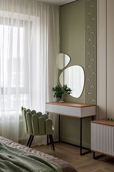 a bedroom with a bed, chair and mirror on the wall next to a window