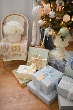 presents under the christmas tree in front of a chair