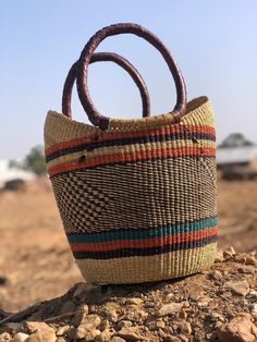 *Our straw U-shopper baskets are handwoven in Bolga Ghana. It can be used as market shopping basket, camping basket, fruit and vegetable storage basket, living space decoration, as natural gift ideas for ladies.  * Its colorful and authentic African designs and high aesthetic value give your living space that lively and natural touch. Care - To reduce shipping costs and other conditions beyond our control during shipping, baskets may be received "crushed." - To regain the perfect basket stature, Woven Basket Bucket Bag For Shopping, Woven Basket-shaped Bucket Bag For Shopping, Multicolor Bucket Bag For Market, Shopping Handwoven Basket Bucket Bag, Handwoven Basket Bucket Bag For Shopping, Market Basket Straw Bag With Rolled Handles, Shopping Bucket Straw Bag With Rolled Handles, Brown Basket-shaped Straw Bag With Top Carry Handle, Brown Basket Shaped Straw Bag With Top Carry Handle