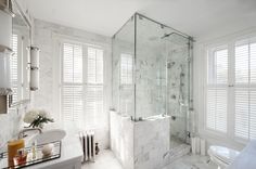 a bathroom with white walls and marble floors