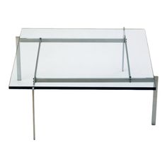 a glass table with metal legs on a white background and no one in the photo