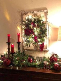 a christmas mantle with candles and decorations on it