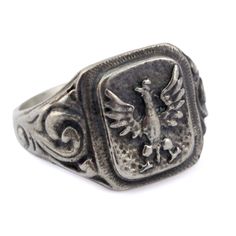 This ring is based on an original from the January 1863 uprising by the Polish and Lithuanians against the Russian Empire. The uprising began in January of 1863 and ended in 1865. .925 proof Sterling Silver Ring face measures 0.5" x 0.56" Made in Poland Antique Silver Signet Ring For Commemoration, Heirloom Silver Rings For Commemoration, Classic Etched Jewelry For Commemoration, Classic Sterling Silver Rings For Commemoration, Classic Silver Rings For Commemoration, Antique Sterling Silver Ring For Commemoration, Silver Victorian Signet Ring With Polished Finish, Victorian Silver Signet Ring With Polished Finish, Antique Engraved Silver Signet Ring