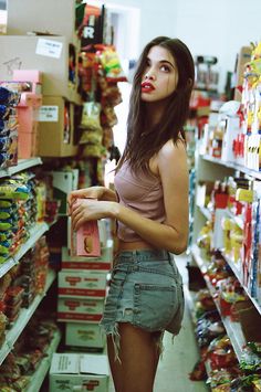 a woman is standing in the aisle of a store