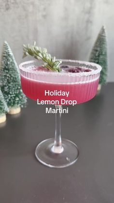 holiday lemon drop martini with pine trees in the background