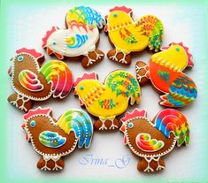 decorated cookies are arranged in the shape of roosters