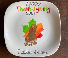 a thanksgiving plate with a turkey and leaves on it