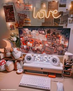 an alarm clock sitting on top of a desk next to a keyboard