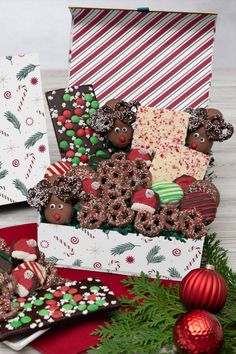 christmas treats are arranged in boxes on the table