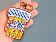 a bottle shaped keychain with an ad for teethpaste on it's side